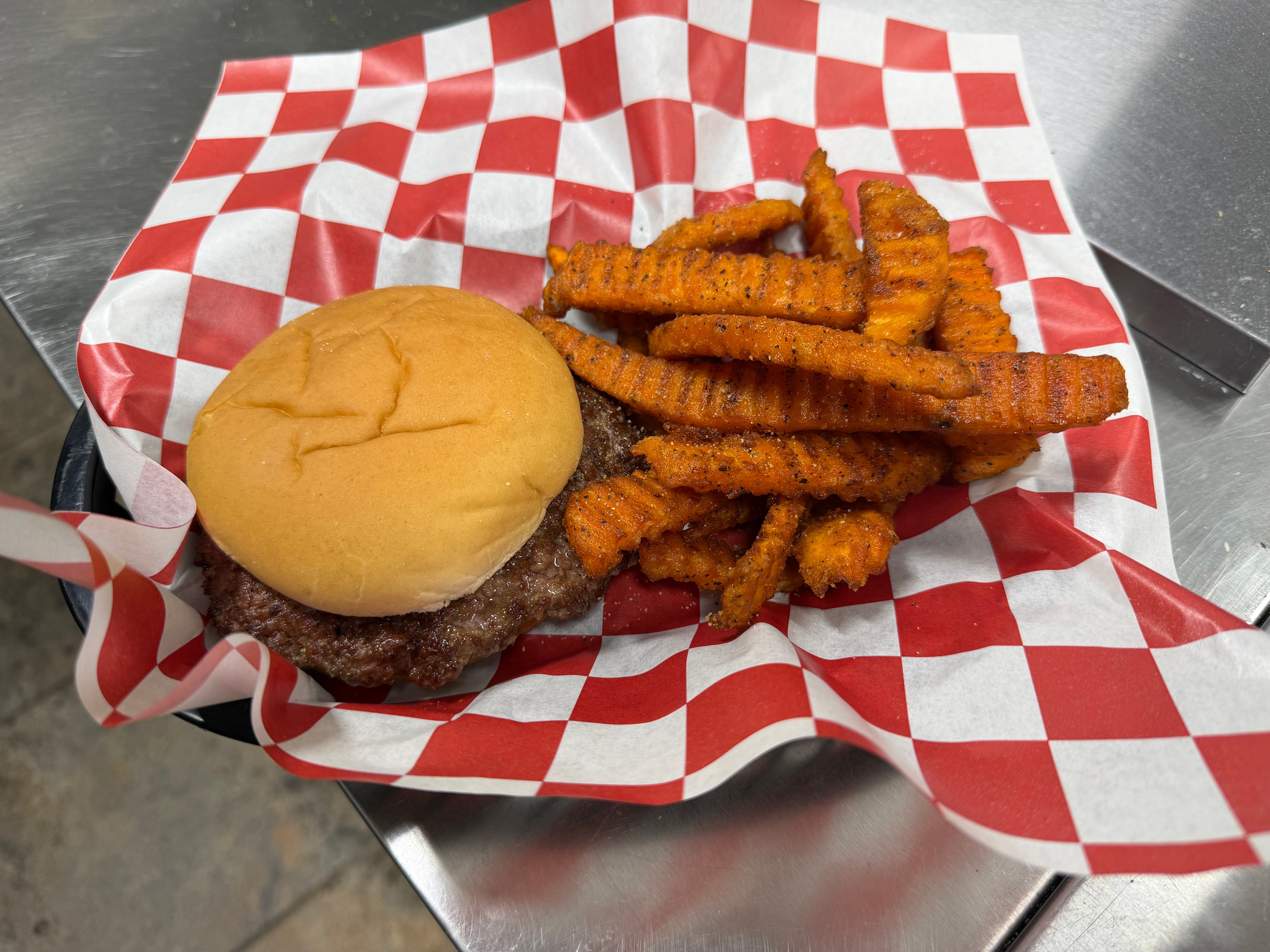 Burger with sweet potato fries at Nina's