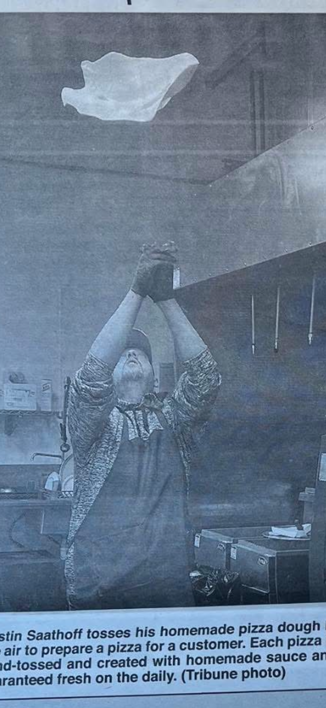 Newspaper feature — dough toss at Nina's Pizza Shop