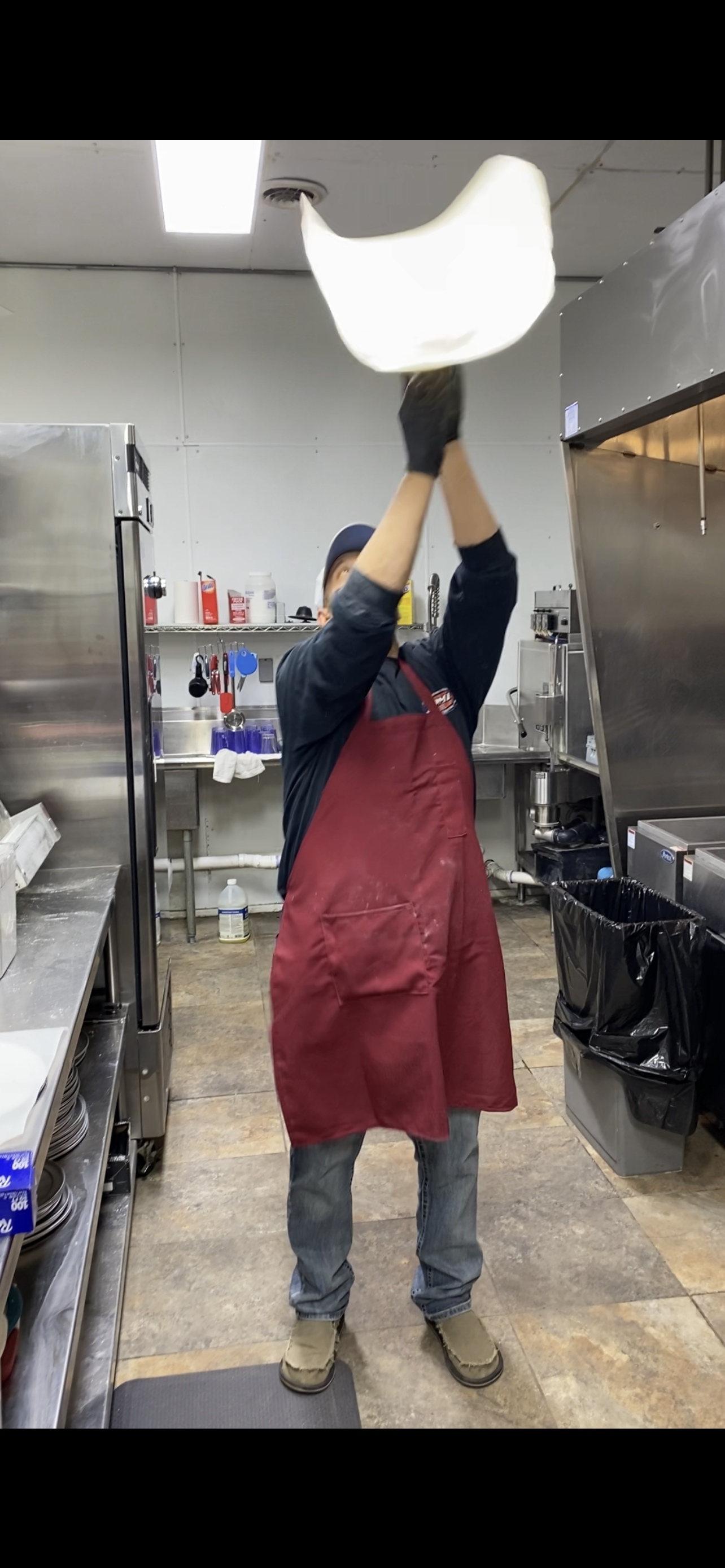 Dough toss — mid-air at Nina's Pizza Shop